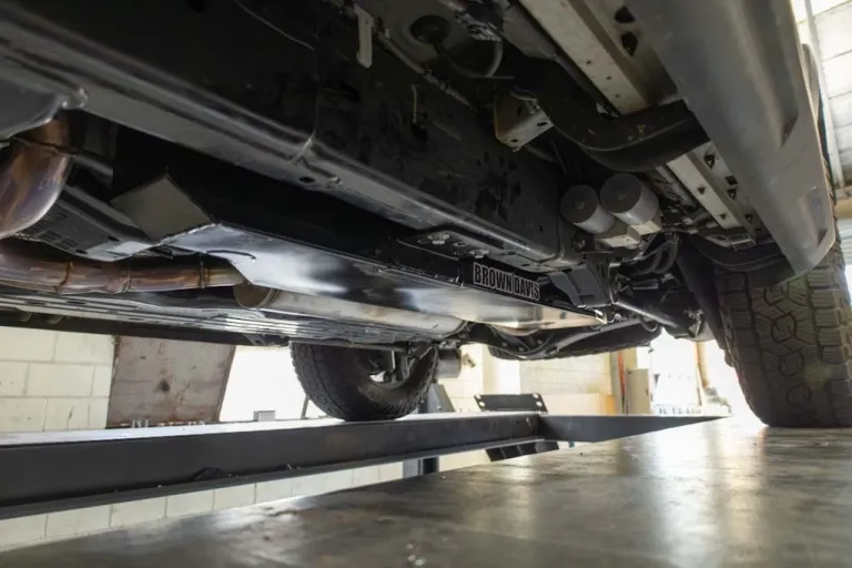 Installed Brown Davis 81-litre auxiliary fuel tank mounted on Lexus GX550 with new exhaust section and underbody hardware