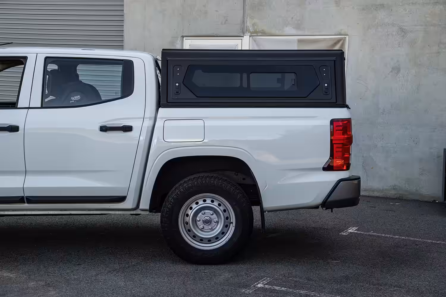 Side view of Alu-Cab Contour Canopy fitted to Mitsubishi MV Triton with solid panel or window options and integrated roof rails